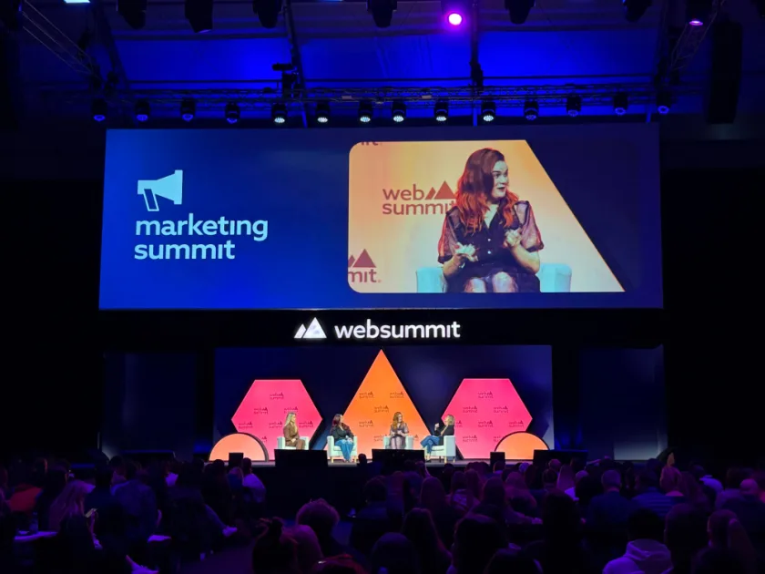 Stephanie on a panel at Web Summit, on the screen over the stage
